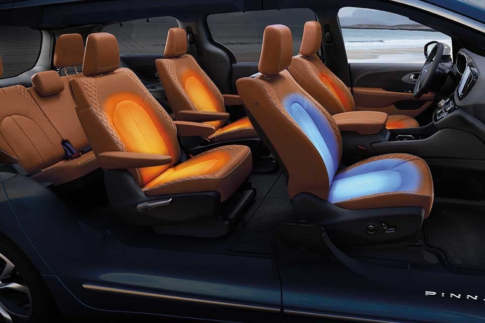 Interior of the 2026 Chrysler Pacifica featuring illuminated heated and ventilated premium leather seats in tan.