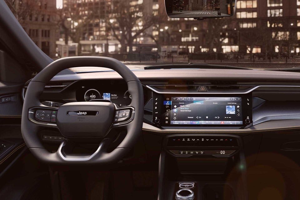 Interior of the 2026 Jeep Cherokee showcasing a modern dashboard with digital display and touchscreen infotainment system.
