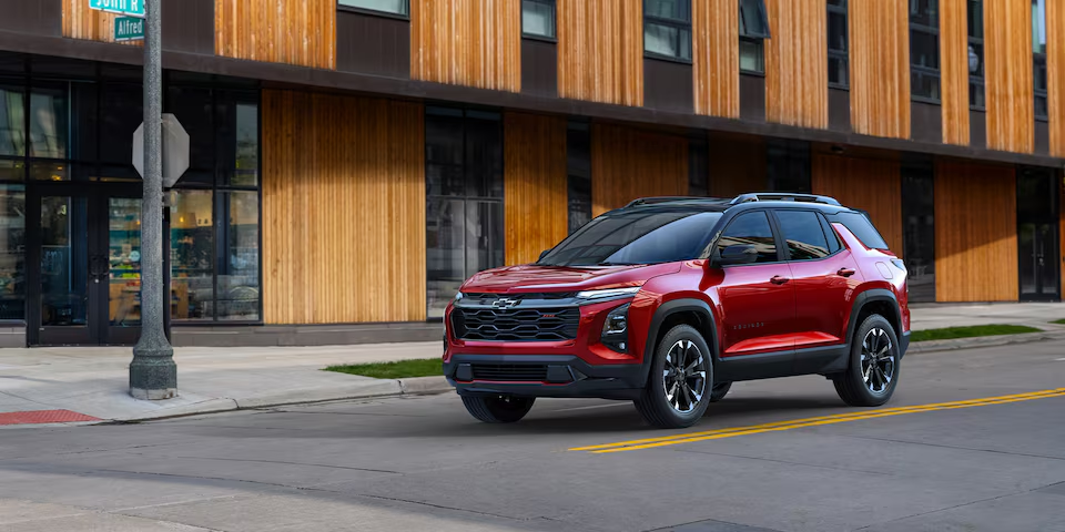2025 Chevrolet Equinox compact SUV parked in front of a modern building