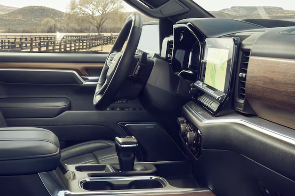 Cabin of the 2026 Chevrolet Silverado 1500 featuring premium materials, a digital display, and a wood-accented dashboard