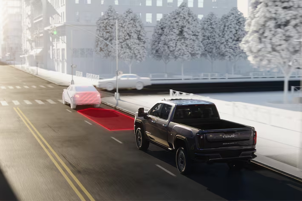 2026 GMC Sierra HD using driver-assist technology with Forward Collision Alert visualized on the road ahead