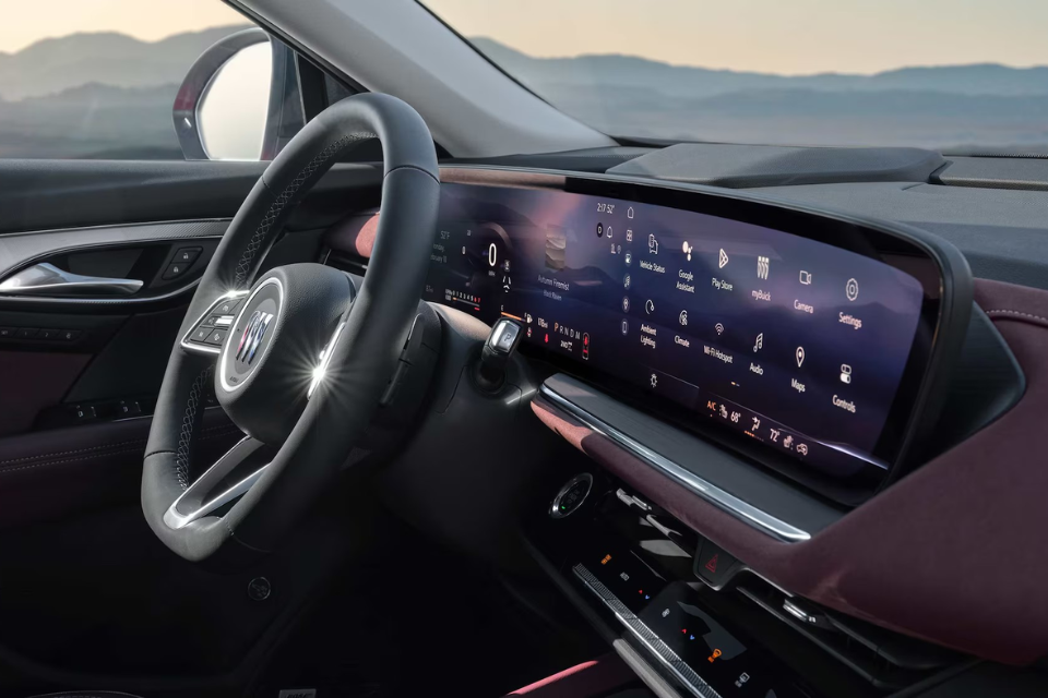Driver-focused cockpit of the Buick Envision with a curved digital display and multifunction steering wheel