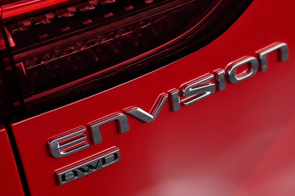 Close-up of the Buick Envision AWD badge on the rear tailgate beneath the LED taillight