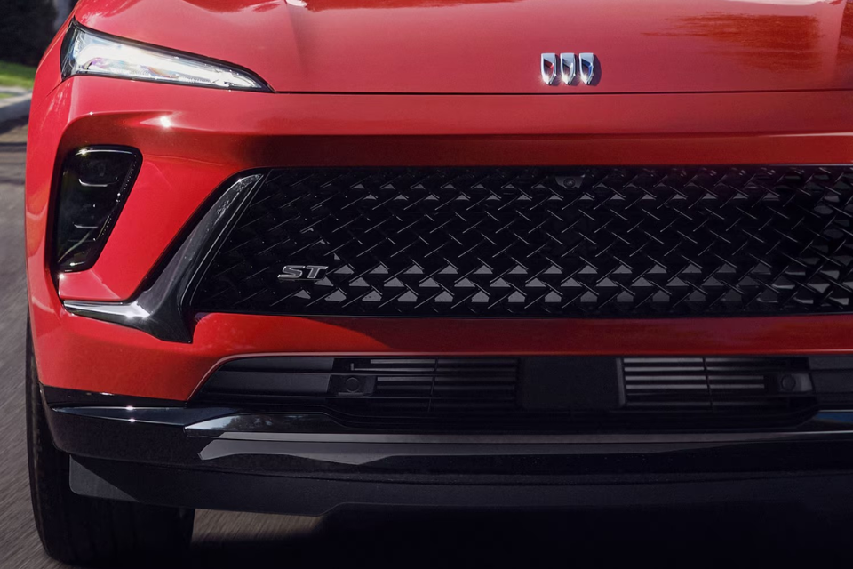 Close-up of the Buick Envision ST front grille with black mesh pattern and ST badging