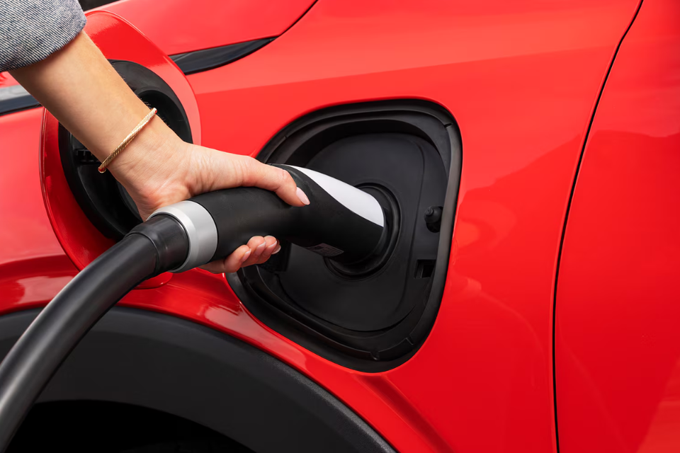 Close-up of the 2027 Chevrolet Bolt EV charging port with connector plugged in