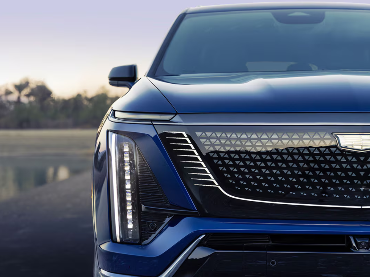 Detailed view of the 2026 Cadillac VISTIQ’s illuminated black crystal grille with geometric pattern and signature vertical LED lighting