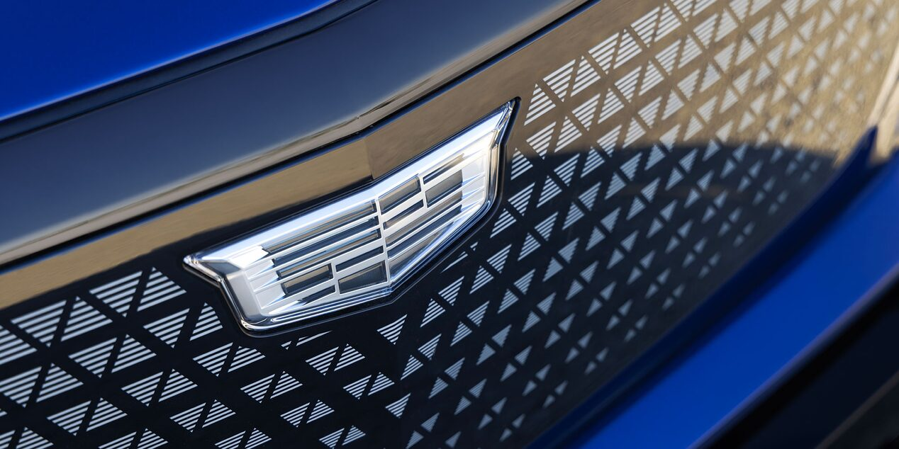 Cadillac crest set against a black crystal grille with geometric pattern detailing