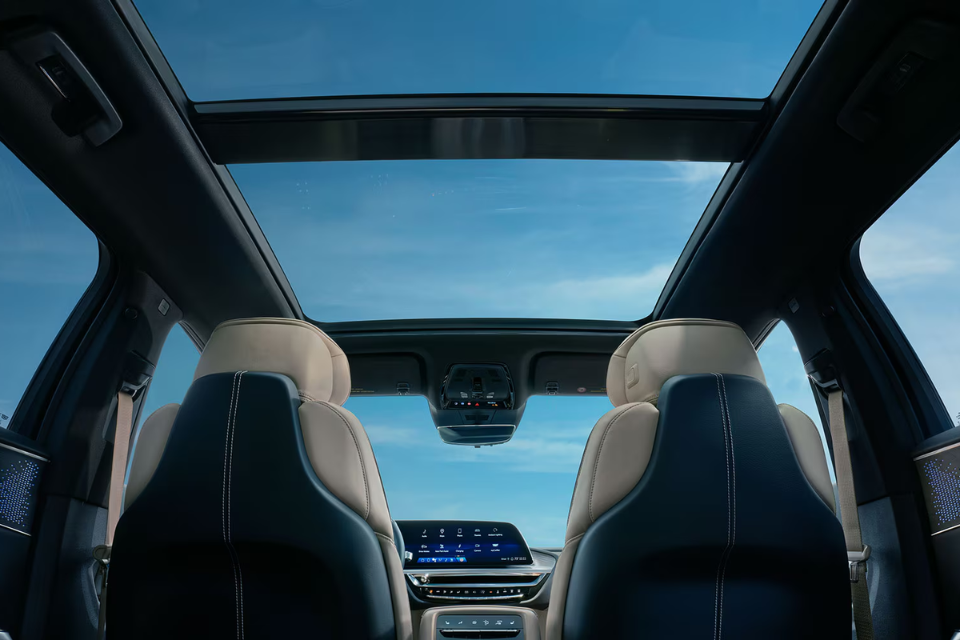 Interior view of the 2026 Cadillac Lyriq featuring a panoramic glass roof and premium two-tone seating