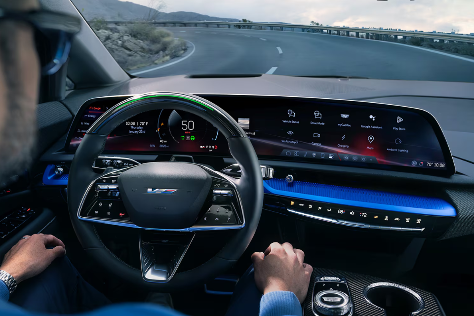 Cockpit view of the 2026 Cadillac Optiq showing the advanced digital dashboard and steering wheel controls in action