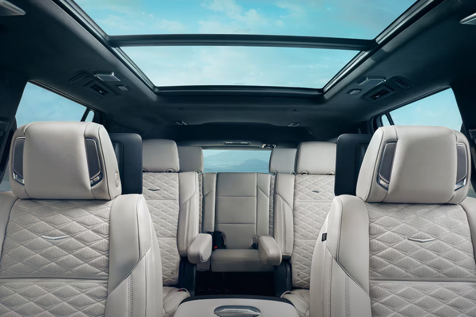 Spacious three-row interior of the 2026 Cadillac Escalade with premium quilted leather seating and panoramic sunroof