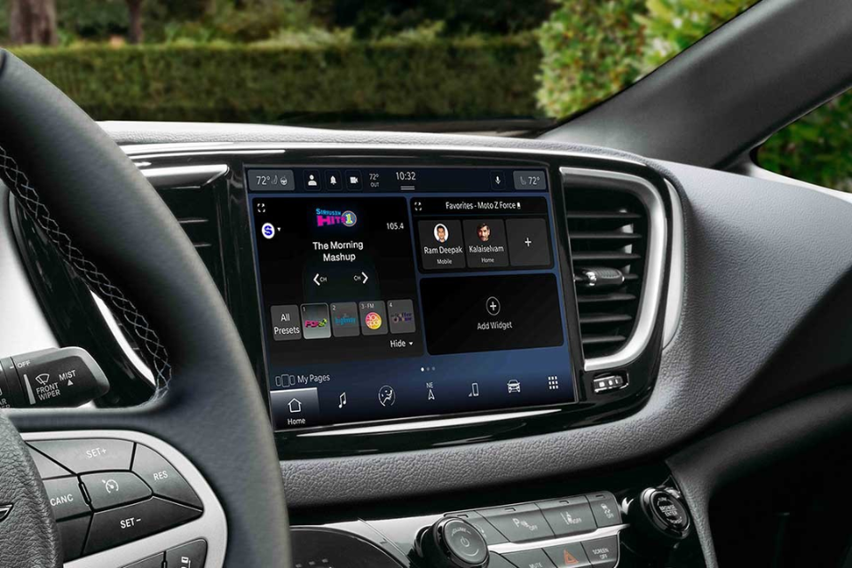 Close-up of the 2026 Chrysler Grand Caravan infotainment touchscreen displaying connected apps and vehicle settings