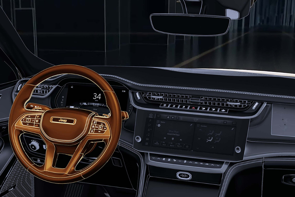 Driver’s seat perspective showing the Grand Cherokee steering wheel, digital gauges, and widescreen display